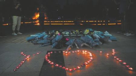 2018 年 6 月 26 日,庆阳市民献上花束与烛光,悼念逝去的年轻生命。